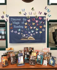 a table topped with lots of books and butterflies