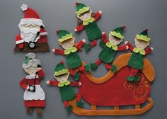 felt christmas decorations with santa and elves on sleigh