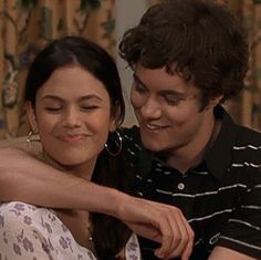 the young man is hugging the woman on the couch