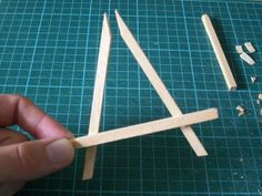 a person is making popsicle sticks out of wood