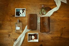 an assortment of personal items laid out on top of a wooden table next to photos