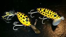 three yellow and black fishing lures sitting on top of each other