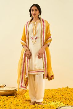 Daisy ivory kurta with gota patti work and highlighted with basra moti. Paired with salwar and glaze mustard dupatta.
Component: 3
Pattern: Embroidered
Type Of Work: Gota and Bead Work
Neckline: Mandarin
Sleeve Type: Long Sleeves
Fabric: Kurta - Silk Chanderi; Salwar - Bamberg Satin; Dupatta - Silk Organza
Color: White
Other Details: 
Gota and bead work
Embroidered dupatta
Occasion: Wedding,Mehendi - Aza Fashions Sheetal Batra, Gota Patti Embroidery, Satin Dupatta, Wedding Mehendi, White Kurta, Embroidered Dupatta, Indian Fashion Designers, Pernia Pop Up Shop, Silk Organza