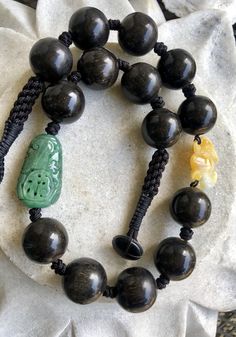 Carved Green Jade Shou Bead Yellow Jade Bat Nut Seed Bead Vintage Necklace Luxury Hand-strung Beaded Necklace With Round Beads, Traditional Hand Knotted Necklaces With Round Beads, Traditional Hand-knotted Necklaces With Round Beads, Traditional Hand Knotted Round Bead Necklaces, Black Hand-knotted Jewelry With Round Beads, Black Hand Knotted Adjustable Necklace, Adjustable Black Hand Knotted Necklace, Artisan Hand Knotted Beaded Necklaces With Round Beads, Artisan Hand Knotted Beaded Necklace With Round Beads