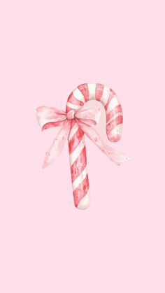 a candy cane on a pink background