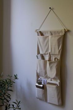 a wall hanging organizer with three pockets