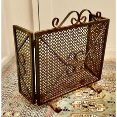 an ornate iron fireplace screen sitting on top of a rug