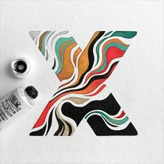 an artistically designed letter k is painted with acrylic and watercolors