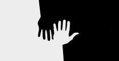 the silhouette of a person reaching out from behind a wall with their hands on it