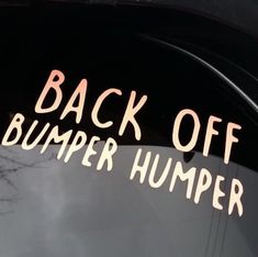 back off bumper sticker on the side of a car with trees in the background