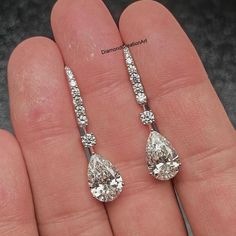 Moissanite Dangle Drop Earrings, 5.40 tcw Pear Cut Moissanite Drop Earrings, 14K White Gold Wedding Earrings, Engagement Bridal Earrings Detail about stones Moissanite & Simulated Stone: ----------------------------- ➠Stone Shape : Pear ➠Stone Size : 11x8 MM ➠Weight: 5.40 TCW ➠Color: Colorless ➠Cut: Excellent ➠Clarity: VVS ✍This Listing's images are only for Imagin about this item. This is all our photography. If you place the order then the same item we can make it. ✍ This displayed all product Hand Set White Gold Teardrop Bridal Earrings, White Gold Hand Set Teardrop Earrings, Hand Set Teardrop Bridal Earrings In Fine Jewelry Style, Hand Set Teardrop Bridal Earrings Fine Jewelry, Elegant Hand-set Pear-shaped Earrings, Elegant Hand Set Pear-shaped Earrings, Hand Set Diamond Teardrop Bridal Earrings, Dazzling Teardrop Bridal Earrings For Anniversary, Fine Jewelry Hand Set Teardrop Diamond Earrings