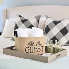 a tray with bottles and soaps on a bed