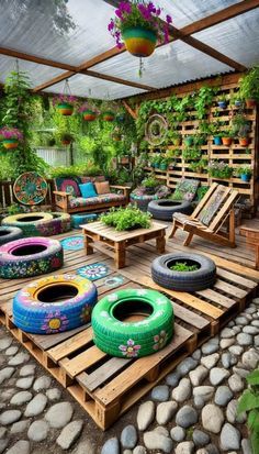 an outdoor seating area with lots of tires on the floor and plants growing in pots