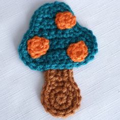 a crocheted mushroom with orange buttons on it