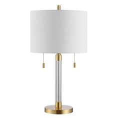 a table lamp with a white shade on the top and gold trimming around it