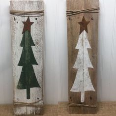 three wooden christmas trees painted on wood planks