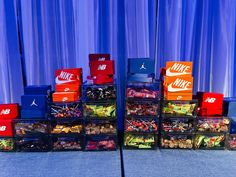 a stack of nike boxes sitting on top of a blue floor next to a wall