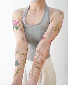 a woman with many tattoos on her arms