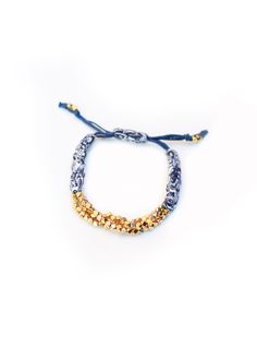 "Gold Cluster Nugget Bracelets are handmade in New York City with Indigo Bandana. Prasada in Sanskrit means \"God's Blessing\". Nugget is a symbol of good fortune. This Prasada bracelet is a nice gift with great intention for yourself and your beloved.  It adds a romantic bohemian touch to your wrist to complete a casual chic look. The length of the bracelet is adjustable." Bohemian Gold Beads Wrap Bracelet As Gift, Gold Resizable Beaded Bracelets For Festival, Bohemian Bracelets With Gold Beads For Gifts, Adjustable Gold Bead Bracelet As Gift, Gold Beaded Friendship Bracelets For Festivals, Gold Hand-strung Wrap Bracelet For Festivals, Adjustable Gold Beads Bracelet As Gift, Traditional Adjustable Beaded Bracelet With Silver Beads, Adjustable Gold Beads Bracelets For Festivals