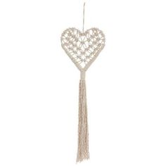 a heart shaped decoration hanging from a string with tassels on the end and an attached