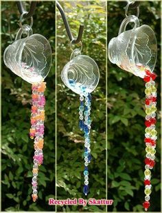 three different colored glass wind chimes hanging from a tree