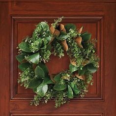 a wooden door with a wreath on it