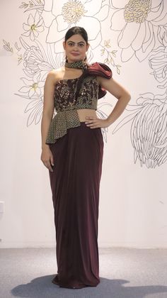 Its a stunning floor-length outfit made from Lycra fabric in an elegant Burgundy color. It features One Side Shoulder. It is embellished with intricate work including Cutdana, Sequins, and Stonework, making it a beautiful choice for special occasions and events. Complete the look by wearing Stone jewelry and bracelet. There might be little color variations in the image and original product due to photographic lightings or your monitor settings. Style: Gown Fabric: Lycra, Net Work: Stonework, Seq Party Wear Semi-stitched Pre-draped Saree For Reception, Semi-stitched Party Wear Pre-draped Saree For Reception, Hand Embellished Georgette Party Gown, Hand Embellished Floor-length Dress For Party Wear, Hand Embellished Floor-length Dress For Party, Hand Embellished Floor-length Party Dress, Elegant Fitted Pre-draped Saree For Party Season, Elegant Chinon Gown, Party Wear Semi-stitched Gown Hand Embellished