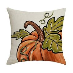 a decorative pillow with an orange pumpkin and green leaves on the front, sitting on a white background