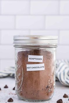 a glass jar filled with hot chocolate chips and topped with a label that says adaptgen hot chocolate