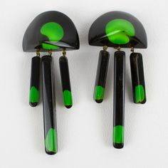 This is part of Chairish’s Costume Jewelry assortment.  Stunning modernist Lucite dangling clip-on earrings. Carved dimensional geometric shape with black Lucite background topped with green gumdrops inclusions embedded in yellow apple juice Lucite. No visible maker's mark. Measurements: 3.19 in high (8 cm) x 1.38 in.wide (3.4 cm).  Please see the measurements noted above in the description for the best approximate dimensions. Yellow Apple, Makers Mark, Costume Jewelry, Geometric Shapes, Clip On Earrings, Carving, Good Things, Green, Black