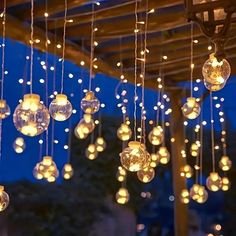 a bunch of lights hanging from a wooden structure