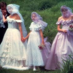 three women in wedding gowns standing next to each other