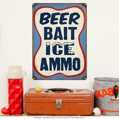 an old fashioned beer sign on the wall next to two ice buckets and a soda can