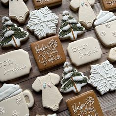 decorated cookies are arranged on a wooden table