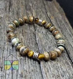 This semiprecious stone bead bracelet features agate and tiger's eye semiprecious stones. This multistone stretchable bead bracelet is an easy everyday wear.  Perfect for the stackable bracelet look Him Gifts, For Him Gifts, Tiger Eye Bracelet, Wire Rings, Stackable Bracelets, Eye Bracelet, Aquamarine Rings, Natural Aquamarine, Tiger's Eye