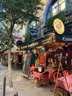 the outside of a restaurant with tables and chairs