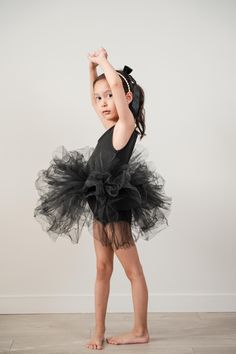 The classic ballet tutu dress is designed for the spotlight. It features a soft scoop neck leotard paired with a fluffy, four-layer tulle skirt, making it perfect for your little princess to twirl in all day.  It also includes a flexible snap closure at the crotch, making it easy to put on and take off. Available in dusty pink, black, and white.  Care instructions: Hand wash in cold water with care and lay flat to dry. The tulle becomes fluffier after washing.  Materials: tulle and polyester. Party Ballet Tutu Dress With Ruffles, Black Princess Tutu Dress With Ruffles, Ballet Pancake Tutu, Two Piece Ballet Tutu, Black Tulle Tutu Dress For Dress-up, Tutu Ballet, Layered Tulle Skirt, Ballet Tutu, Tutu Dress