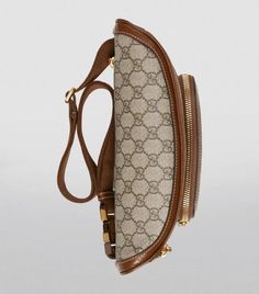 The distinctive GG Supreme motif has been a defining feature of all of Gucci’s collections since the 1930s; here it’s emblazoned on durable canvas for the label’s recurring belt-bag silhouette. Sleek and compact, it has a discreet zipped pocket, chunky gold-tone hardware and an adjustable strap you can wear across the body or around the waist for a utilitarian look. Luxury Coated Canvas Belt Bag For Everyday, Gucci Beige Bag With Logo, Vintage Gucci Bag With Removable Pouch, Classic Monogram Canvas Belt Bag With Removable Pouch, Luxury Belt Bag With Removable Pouch In Coated Canvas, Brown Leather Gucci Belt Bag, Luxury Brown Belt Bag With Removable Belt, Designer Brown Belt Bag For Travel, Gucci Brown Leather Belt Bag