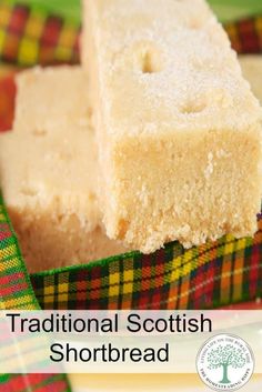 two pieces of shortbread sitting on top of a plaid table cloth with the words traditional scottish shortbread