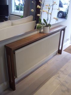 a white radiator sitting on top of a wooden table