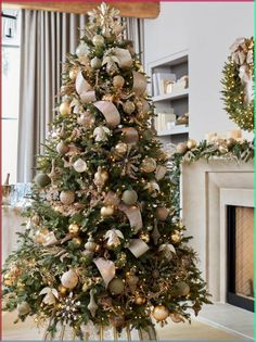 a decorated christmas tree in a living room with gold and silver ornaments on the top