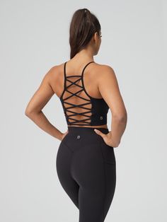 Features: High neckline Lattice back strap detail Removable bust pads Cropped fit Details: Fabric: Energy (Nylon/Spandex) Light — Medium Support Description: This Ivy Crop has a removable bust pads, a high neckline, and a cropped length. The back features a lattice back strap detail and it is made with our Energy fabric for light compression and an ultra-soft, breathable feel. Fitted Sports Bra With Built-in Bra And Cross Back, Black Adjustable Straps Crop Top For Gym, Black Adjustable Straps Crop Top For Workout, Black Crop Top With Adjustable Straps For Gym, Black Gym Crop Top With Adjustable Straps, Sporty Fitted Crop Top With Strappy Back, Black Workout Crop Top With Adjustable Straps, Black Top With Built-in Bra And Strappy Back, Black Tank Top With Built-in Bra And Strappy Back