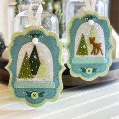 two christmas ornaments are sitting on a shelf