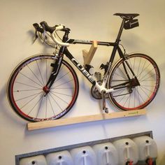 a bicycle mounted to the wall with several urinals on it's sides