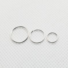 These minimalist and modern cartilage hoops are made from 20 gauge wire and are hand forged by me. These are ear hugging hoops in your lobe piercings, as shown in the photo. This listing is for a single endless hoop in 20 gauge wire handcrafted tiny size nose ring/hoop earring. Classic and simple design, great for everyday, lightweight and very comfortable. They would also work as for all your piercings, 2nd and 3rd piercings, helix, nose and tragus. These delicate and lightweight hoops are appr Helix Hoop, Cartilage Hoop, Cartilage Earrings Hoop, Nose Rings Hoop, Lobe Piercing, Helix, Tragus, Body Jewelry, Solid Gold