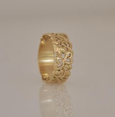 "This 14k gold ring, is unique and very special wedding band. This wide gold ring is full of \"love hearts\" dancing and swirling in random order. This ring can be a wonderful anniversary gift for the one you love. Each heart is meticulously hand crafted and is inimitable and different from all the other. Three full hearts complement the hollow ones around the band. The ring has a solid, plain, smooth bottom part for extra comfort. The ring is wide but has a light and gentle appearance. It can b Yellow Gold Wedding Jewelry For Valentine's Day, Yellow Gold Wide Band Wedding Ring, Gold Wedding Rings For Valentine's Day, Heirloom 14k Gold Wide Band Wedding Ring, Hallmarked Wide Band Ring For Wedding, Yellow Gold Wide Band Engraved Wedding Ring, Heirloom Yellow Gold Wide Band Ring For Wedding, Engraved Wide Band Ring With Decorative Detail For Wedding, Wedding Engraved Ring With Decorative Wide Band