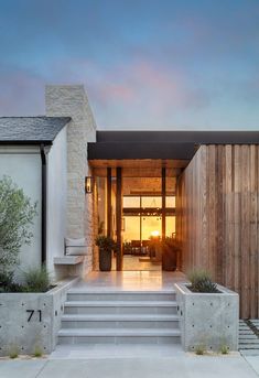 the entrance to a modern home at sunset