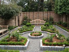 a garden with benches and plants in the center, surrounded by brick walling on both sides