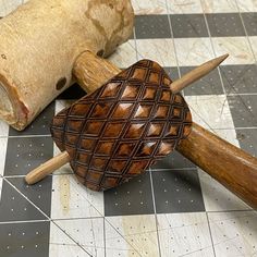 two wooden mallets sitting on top of a tiled floor