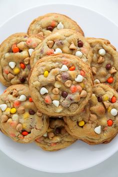 a white plate topped with cookies covered in candy corn and m & m's